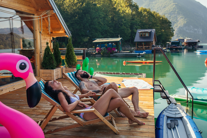 a couple relaxes by a lake