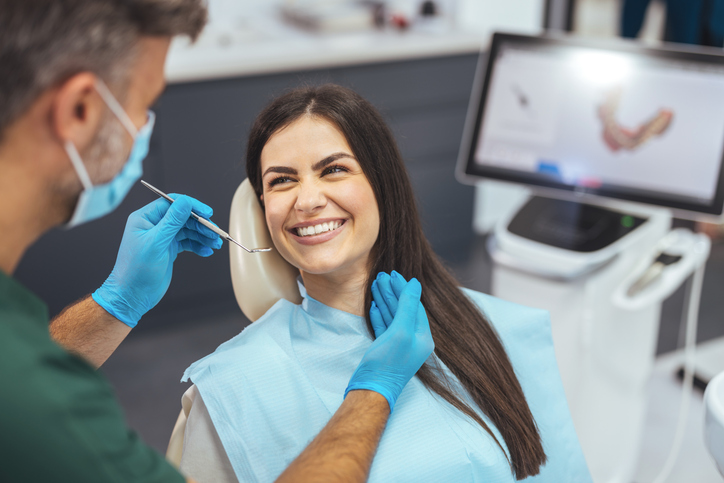 a woman being treated by a dentist
