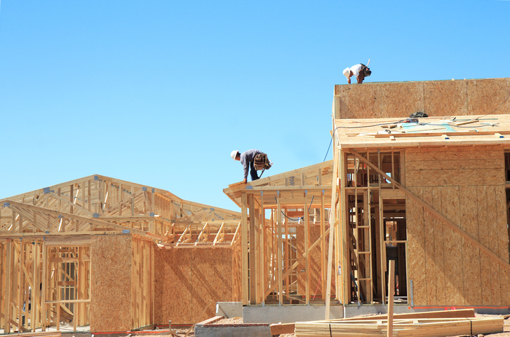 workers build home on a construction site