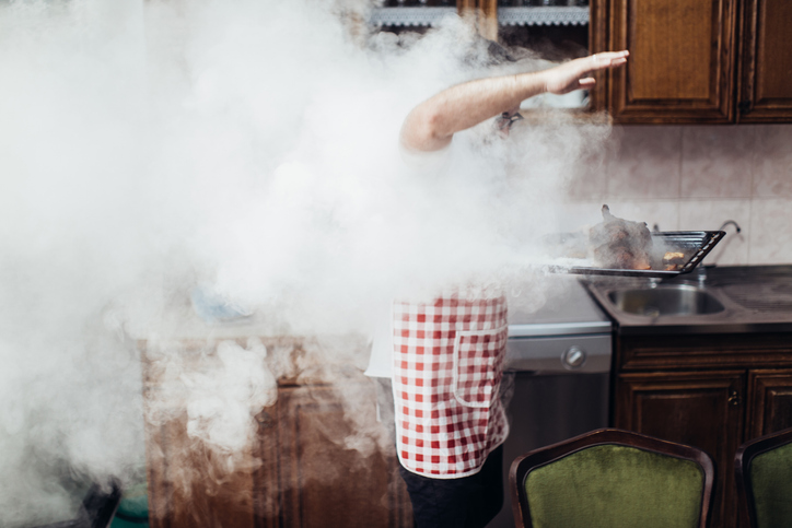 a person surrounded by smoke from a kitchen fire